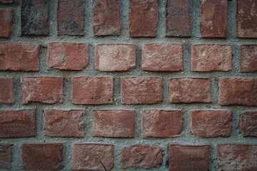 Close-up of red wall background. Premium colorful abstract background with dynamic shadow on background, consisting of red bricks and stones, gradient color, artistic texture, epic background