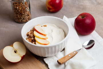 Healthy breakfast of apples, granola and yogurt