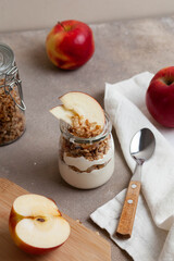 Healthy breakfast of apples, granola and yogurt