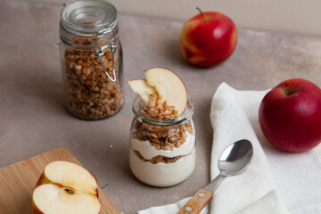 Healthy breakfast of apples, granola and yogurt