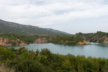 Beautiful image of the cortes del pallas reservoir with the mountain cuts and its grove everywhere in the Valencian community, Spain