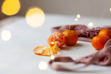 mandarins in a pink string bag and garland light bokeh
