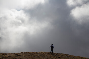 Hiker on the summit of a mountain with snow