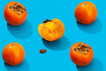 persimmon fruit on a blue background isolated