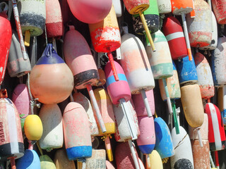 Colorful lobster buoys hanging in the sunshine - obrazy, fototapety, plakaty