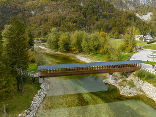 Slovenia - View of the Slovenian river with mountains and autumn colors on the trees from drone view