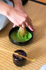 Japanese woman, tea master, Sen Rikyu whisking matcha tea in chawan tea bowl © A Certain Aesthetic
