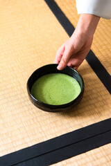 Japanese woman, tea master, Sen Rikyu hand serving matcha tea in chawan tea bowl © A Certain Aesthetic