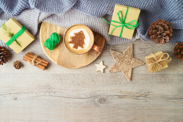 Christmas holiday concept with coffee cup and decorations on wooden background. Hygge Scandinavian style cozy winter. Top view, flat lay