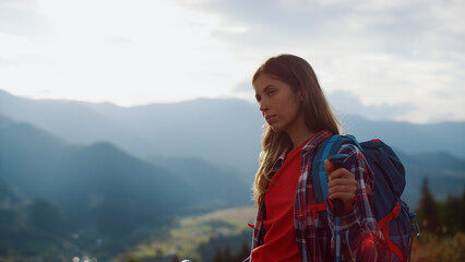 Naklejka premium Closeup tired traveler going nature. Beautiful woman wear backpack in mountains.