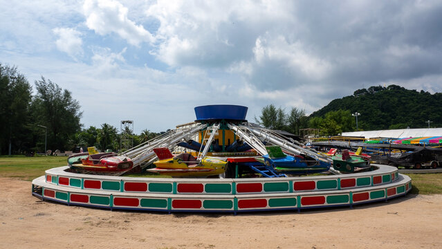 Amusement park ride machine near SAMILA beach. Colorful retro cars at a children playground in a park.