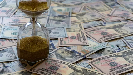 Sierkussen time is money concept hourglass with dollars © reznik_val