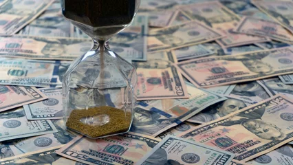 Zelfklevend Fotobehang time is money concept hourglass with dollars © reznik_val