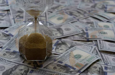 Keuken spatwand met foto time is money concept hourglass with dollars © reznik_val