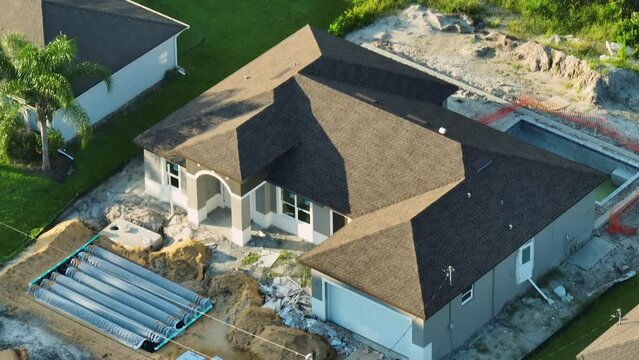 Aerial view of residential private home under construction and yard ground works with septic drain field installation in Florida quiet rural area. Real estate development concept