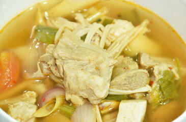 hot and spicy pork bone with tamarind and Thai herbs soup on bowl 
