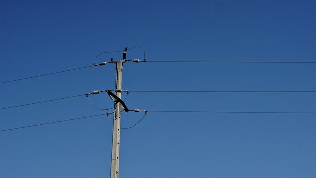 electric post against blue sky