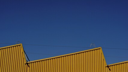 industrial warehouse roof against blue sky