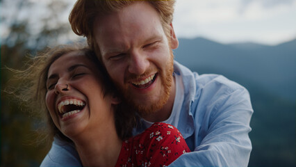 Cheerful couple laughing mountains. Closeup happy people face spending honeymoon
