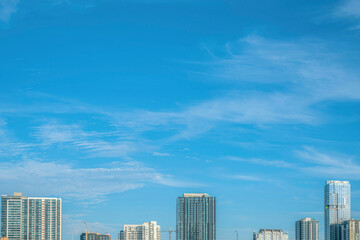 Fototapeta premium Austin, Texas- Skyscraper towers below the blue sky and clouds above