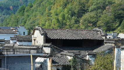 Fototapeta na wymiar The beautiful traditional Chinese village view with the classical architecture and fresh green trees as background