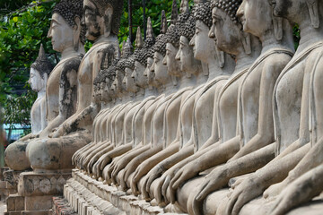 Ruins of pagodas, monks and walls that remain of Wat Yai Chaimongkol, Ayutthaya, Thailand, were...