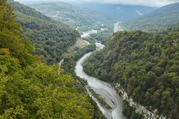 A swift mountain river. Water flows in nature. Mountainous terrain.