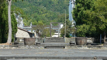 The beautiful traditional Chinese village view with the classical architecture and fresh green trees as background