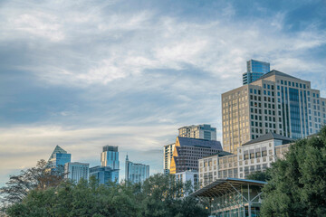 Fototapeta na wymiar Austin, Texas- District area of Austin with high-rise buildings against the cloudy sky