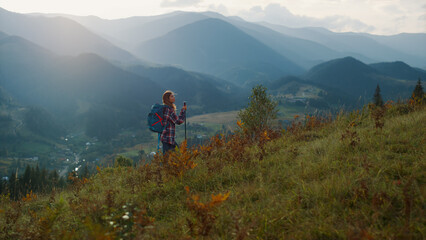 Fototapeta na wymiar Active millennial travel mountains nature. Young woman trekking on landscape.