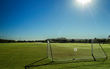 Noon day sun over a soccer field - Powered by Adobe