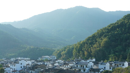 Fototapeta premium The beautiful traditional Chinese village view with the classical architecture and fresh green trees as background