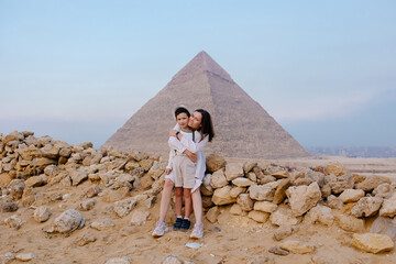 Mother and child together in front of the pyramids in Cairo. Tourist trip to Egypt. Excursion to...