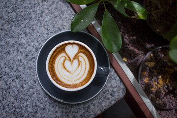 An above shot of a latte on the table at the outdoor seating