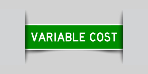 Inserted green color label sticker with word variable cost on gray background