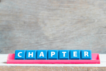 Obraz premium Tile alphabet letter with word chapter in red color rack on wood background