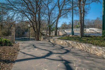 Stone pavement at River Walk near the road and bridge over the San Antonio River- San Antonio, Texas