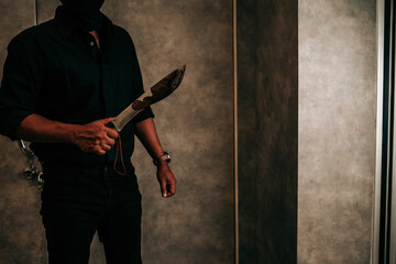 Man in black holding a bloody knife, scared woman victim of domestic violence and kidnapping, Human trafficking, stop abusing violence.copy space. - obrazy, fototapety, plakaty