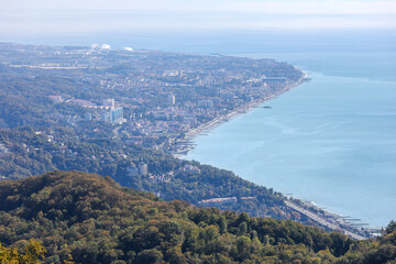 Aerial view of the city on the seashore. A beautiful modern city from a height. Sochi, Russia. Olympic Park.