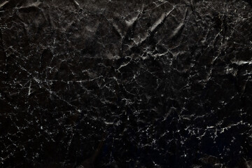 Fototapeta na wymiar Black damaged cardboard paper overlay texture background