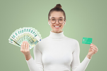 Woman in eyeglasses holding fan of euro banknotes and credit card, choosing between ways of payment