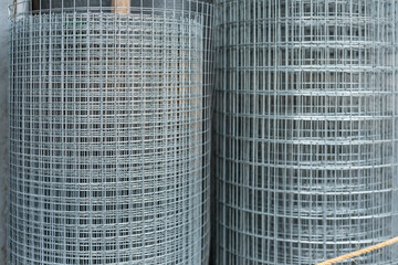 A roll of galvanized steel matting or welded wire mesh for sale at a hardware store.