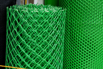 A roll of Green Polyethylene Screen Mesh or Plastic Netting for sale at a hardware store.