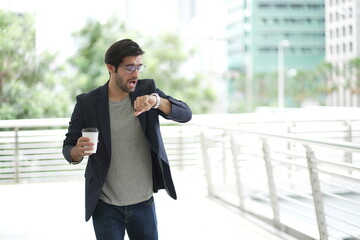 businessman hurry up and running in business city street for rush hour. Young businessman running late to important meeting on sunny morning.