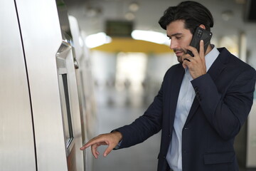 Businessman buying ticket on train station. Asking for price. businessman buying a ticket in a machine on subway station.