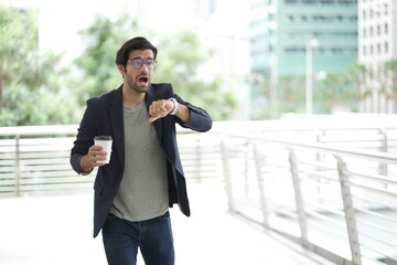 businessman hurry up and running in business city street for rush hour. Young businessman running...