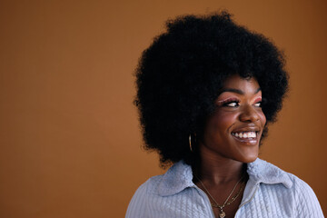 Studio portrait of young beautiful women with afro hair smiling