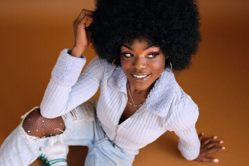 Studio portrait of young beautiful women with afro hair smiling