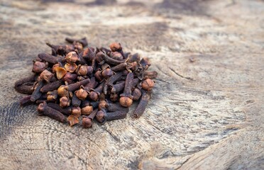Clove Heap Isolated on Wooden Background with Copy Space, Authentic Spices and Condiment
