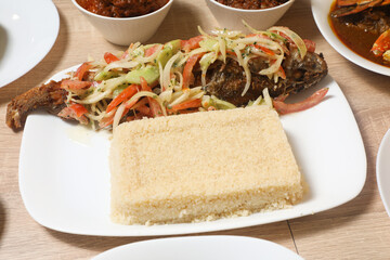 Delicious African dish featuring grilled fish with vegetables and a side of couscous served at a local restaurant
